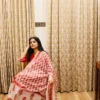 red-cotton-anarkali-suit-with-block-print-dupatta-showing-dupatta-while-model-sitting