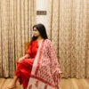 red-cotton-anarkali-suit-with-block-print-dupatta-sitting-side-pose