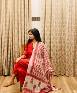 red-cotton-anarkali-suit-with-block-print-dupatta-sitting-side-pose